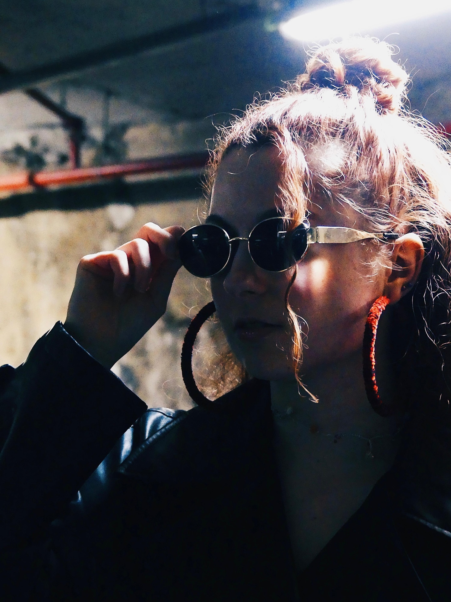 Portrait with round sunglasses under fluorescent light.